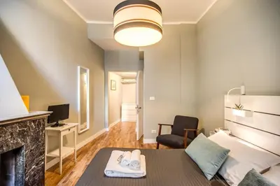 a living room with a bed and a fireplace at Cappellari Campo dei Fiori int 5 in Rome