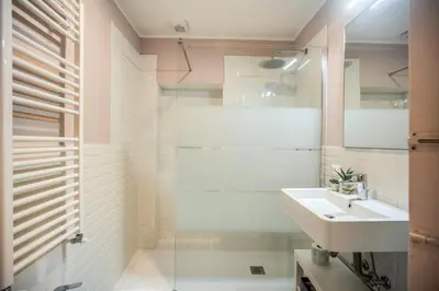 a white bathroom with a sink and a shower at Cappellari Campo dei Fiori int 5 in Rome
