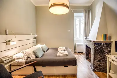 a bedroom with a bed and a fireplace at Cappellari Campo dei Fiori int 5 in Rome