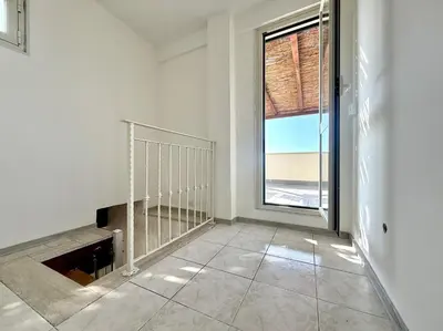 an empty room with a staircase and a window at Marconi Penthouse in Rome