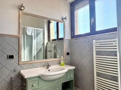 a bathroom with a sink and a mirror at Marconi Penthouse in Rome