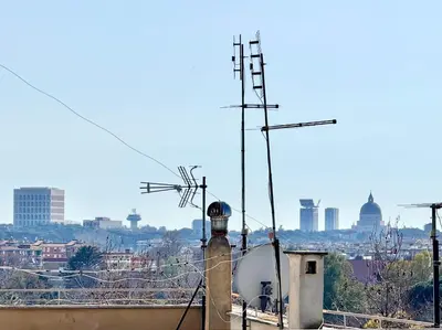 a view of a city from a building with antennas at Marconi Penthouse in Rome