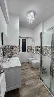 a bathroom with two sinks and a tub and a shower at L'impero dei fiori in Rome