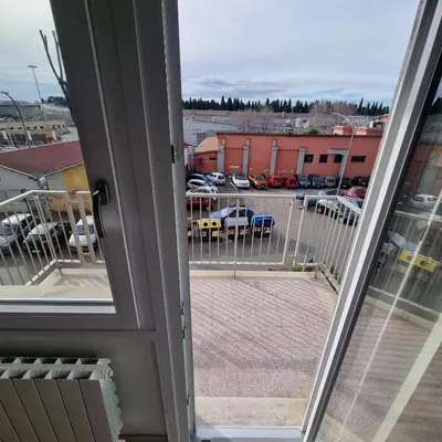 an open window with a view of a parking lot at L'impero dei fiori in Rome