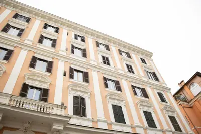 a large building with windows and a balcony at Colosseo Apartment - Domus Claudinae in Rome