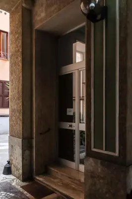 an entrance to a building with a glass door at Colosseo Apartment - Domus Claudinae in Rome