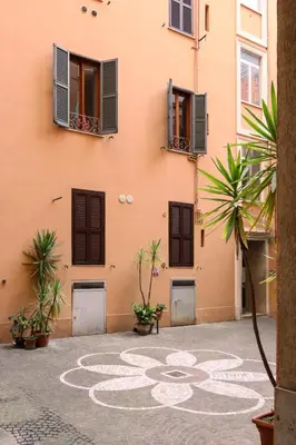 a building with a rangoli on the ground in a courtyard at Colosseo Apartment - Domus Claudinae in Rome