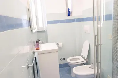 a bathroom with a toilet and a sink at Colosseo Apartment - Domus Claudinae in Rome
