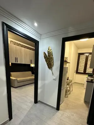a room with a door leading to a living room at lucky home in Trastevere in Rome