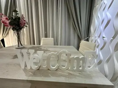 a white table with a vase of flowers on it at lucky home in Trastevere in Rome