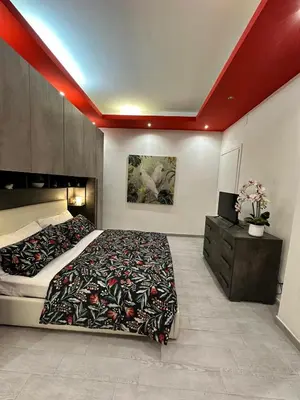 a bedroom with a large bed and a dresser with a bed sidx sidx sidx at lucky home in Trastevere in Rome
