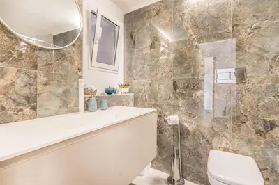 a bathroom with a tub and a toilet and a mirror at Cozy Rome - Newly Renovated Apartment near Vatican City in Rome