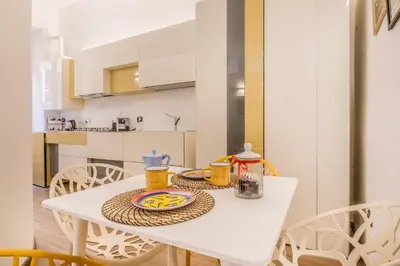 a white table with a plate on it in a kitchen at Cozy Rome - Newly Renovated Apartment near Vatican City in Rome
