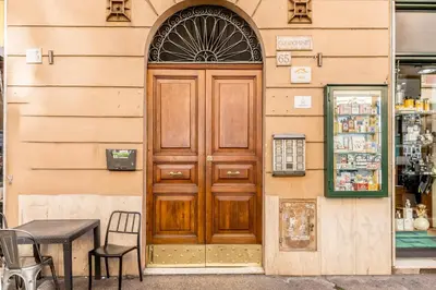 a wooden door on the side of a building at Cozy Rome - Newly Renovated Apartment near Vatican City in Rome