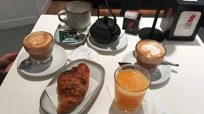 a table with a plate of food and cups of coffee at Kea Alloggio Turistico in Rome