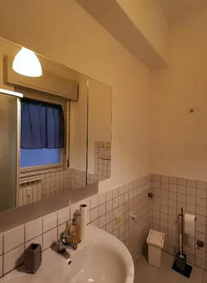 a bathroom with a sink and a mirror at Kea Alloggio Turistico in Rome