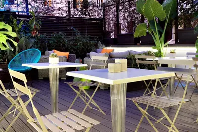 a group of tables and chairs on a patio at Vico Rooms and Terrace in Rome