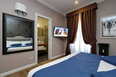 a bedroom with a bed and a flat screen tv at Vico Rooms and Terrace in Rome