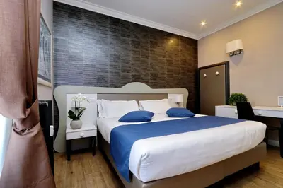 a bedroom with a large bed with blue pillows at Vico Rooms and Terrace in Rome