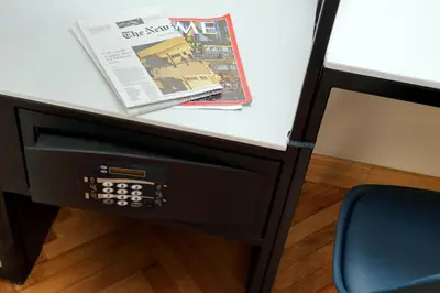 a desk with a newspaper and a magazine on it at Vico Rooms and Terrace in Rome