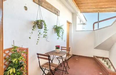 a patio with a table and chairs and plants at Vaticano-Metro A, Penthouse with AC, Wi-Fi e Netflix in Rome