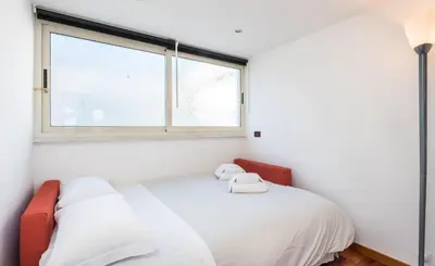 a white bedroom with a bed and a window at Vaticano-Metro A, Penthouse with AC, Wi-Fi e Netflix in Rome