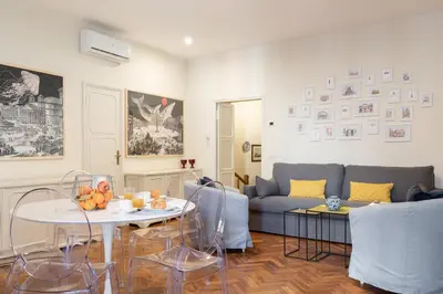 a living room with a couch and a table at Coppelle Charme in Rome