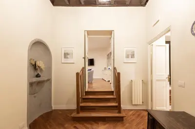 a stairway leading to a hallway with white walls at Coppelle Charme in Rome