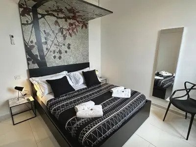 a bedroom with a large bed with towels on it at Domus Symmetrie in Rome