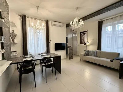 a living room with a table and a couch at Domus Symmetrie in Rome