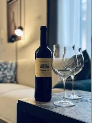 a bottle of wine and a wine glass on a table at Domus Symmetrie in Rome