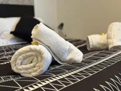 a towel laying on top of a bed at Domus Symmetrie in Rome