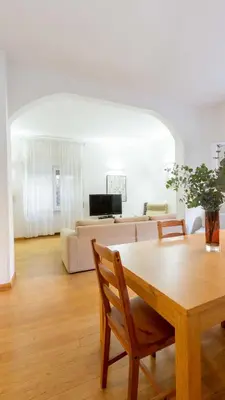 a living room with a table and a couch at Casa Emiliani Ospedale San Camillo - Cale 09 in Rome