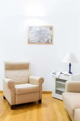 a living room with a chair and a table at Casa Emiliani Ospedale San Camillo - Cale 09 in Rome
