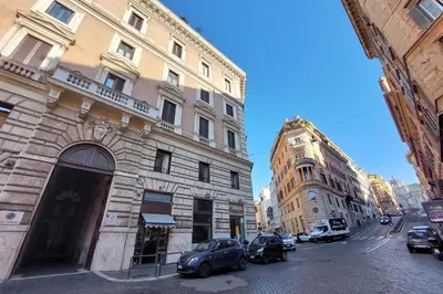 a city street with cars parked in front of buildings at Beautiful Monti apartment Panisperna in Rome