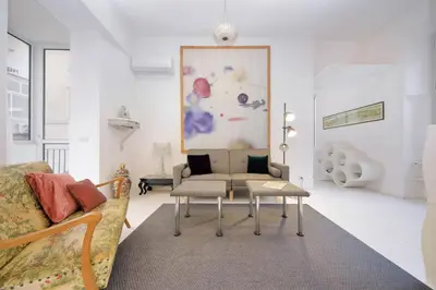 a living room with a couch and a chair at Beautiful Monti apartment Panisperna in Rome