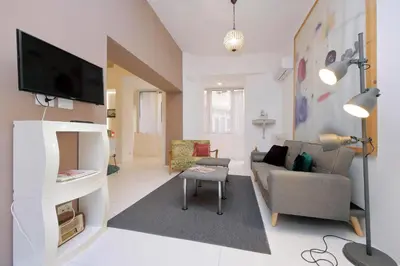 a living room with a couch and a tv at Beautiful Monti apartment Panisperna in Rome