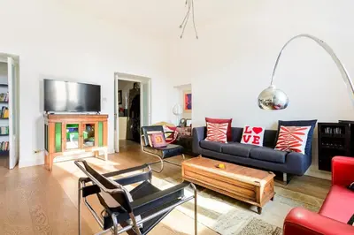 a living room with a couch and a table at Principe House, Central Rome, 3 bedroom 2 bath, Elegant Apartment full of Light in Rome