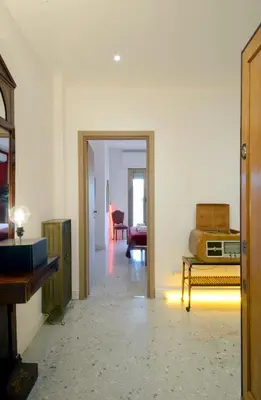 a living room with a door open to a room at Led House Roma in Rome