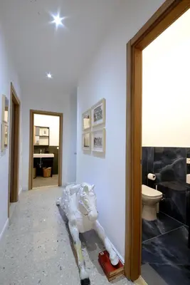 a bathroom with a statue in a room with a toilet at Led House Roma in Rome