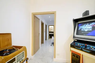 a living room with a television and a hallway at Led House Roma in Rome