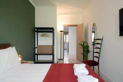 a bedroom with a bed with two towels on it at Led House Roma in Rome