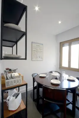 a dining room with a table and chairs at Led House Roma in Rome