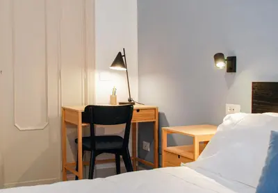 a bedroom with a desk and a chair next to a bed at 50mt Metro Station - 20min walking from Colosseum - RomeCentralHouse - Elegant and fully equipped in Rome