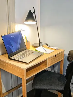 a laptop computer sitting on top of a wooden desk at 50mt Metro Station - 20min walking from Colosseum - RomeCentralHouse - Elegant and fully equipped in Rome