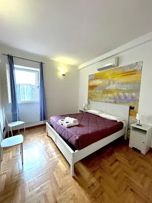 a bedroom with a bed and a painting on the wall at Cellini apartments in Rome