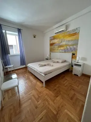 a bedroom with a bed and a painting on the wall at Cellini apartments in Rome