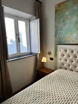 a bedroom with a bed and a window at Cellini apartments in Rome