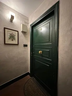 a green door in a room with a picture at Cellini apartments in Rome
