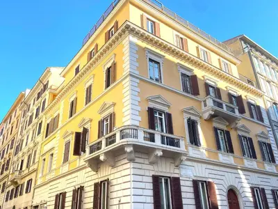 a yellow and white building with a balcony at Monti Lovely Suite in Rome